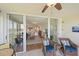 Relaxing balcony area featuring wicker furniture and sliding glass doors leading to a brightly lit living space at 4570 Pinebrook Cir # 508, Bradenton, FL 34209