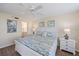 This bedroom offers natural light, a ceiling fan, and coastal artwork at 4570 Pinebrook Cir # 508, Bradenton, FL 34209