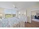 Bright bedroom with golf course views, ceiling fan, and door to balcony at 4570 Pinebrook Cir # 508, Bradenton, FL 34209