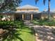 Inviting community building exterior with manicured lawn and brick walkway to front entrance at 4570 Pinebrook Cir # 508, Bradenton, FL 34209