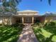 Inviting community building exterior with manicured lawn and brick walkway to front entrance at 4570 Pinebrook Cir # 508, Bradenton, FL 34209