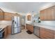 Well-lit kitchen with stainless steel appliances, granite countertops, and wooden cabinets at 4570 Pinebrook Cir # 508, Bradenton, FL 34209