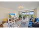 Cozy living room area with a view to the balcony, a couch, and stylish coastal decorations at 4570 Pinebrook Cir # 508, Bradenton, FL 34209