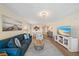 Bright and airy living room with a comfortable blue couch, stylish rug, and an open floor plan to the dining area at 4570 Pinebrook Cir # 508, Bradenton, FL 34209