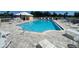 The community pool has tables and chairs for residents to enjoy the weather at 4570 Pinebrook Cir # 508, Bradenton, FL 34209