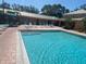 The community pool has a stepped entrance and lots of room for residents and visitors to enjoy at 4570 Pinebrook Cir # 508, Bradenton, FL 34209