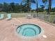 The community spa is easily accessible and surrounded by lounge chairs for relaxation at 4570 Pinebrook Cir # 508, Bradenton, FL 34209