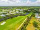 Picturesque aerial view of homes along a golf course, with serene lake views at 4612 Masefield Pl, Sarasota, FL 34241