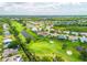 A sweeping aerial view of a golf course community, showcasing lush greenery and waterfront properties at 4612 Masefield Pl, Sarasota, FL 34241