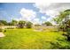 Expansive green backyard with a well-manicured lawn and a serene, fenced perimeter at 4612 Masefield Pl, Sarasota, FL 34241