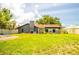 Spacious backyard with lush green grass, a well-maintained lawn, and a charming home exterior at 4612 Masefield Pl, Sarasota, FL 34241