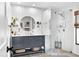Modern bathroom features stylish vanity, round mirror, and glass-enclosed shower with white subway tiles at 4612 Masefield Pl, Sarasota, FL 34241