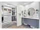 Chic bathroom featuring a gray vanity with ample storage and a walk-in closet at 4612 Masefield Pl, Sarasota, FL 34241