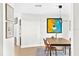 Bright dining area with modern light fixture, wood-look tile, and artistic wall decor at 4612 Masefield Pl, Sarasota, FL 34241