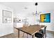 Open-concept dining room with stylish light fixture and adjacent kitchen at 4612 Masefield Pl, Sarasota, FL 34241