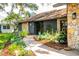 A winding brick path leads to the home's front door, surrounded by lush landscaping at 4612 Masefield Pl, Sarasota, FL 34241