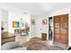 Bright foyer with wood-look tile flooring, vintage-style rug, and contemporary decor at 4612 Masefield Pl, Sarasota, FL 34241