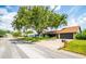 A single-story home with stone accents sits along a paved residential street at 4612 Masefield Pl, Sarasota, FL 34241