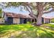 Charming single-story home featuring stone accents, fresh landscaping and a large shade tree at 4612 Masefield Pl, Sarasota, FL 34241