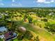 Scenic aerial shot of a golf course with mature trees and verdant fairways at 4612 Masefield Pl, Sarasota, FL 34241