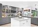Stylish gray cabinets, marble counters, and backsplash add elegance to this kitchen at 4612 Masefield Pl, Sarasota, FL 34241