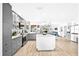 Bright kitchen features gray cabinets, an island, and an open layout to the living area at 4612 Masefield Pl, Sarasota, FL 34241
