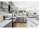 Elegant kitchen with gray cabinetry, marbled countertops, and natural light at 4612 Masefield Pl, Sarasota, FL 34241
