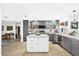 Well-lit kitchen with grey cabinetry, a white island, and an inviting atmosphere at 4612 Masefield Pl, Sarasota, FL 34241