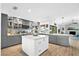 Spacious kitchen with a center island, modern appliances, and gray cabinets at 4612 Masefield Pl, Sarasota, FL 34241