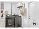 Laundry room featuring modern washer and dryer appliances, shelving, and storage space at 4612 Masefield Pl, Sarasota, FL 34241