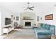 Comfortable living room with stone fireplace, ceiling fan, and neutral decor at 4612 Masefield Pl, Sarasota, FL 34241