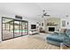 Spacious living room featuring a stone fireplace and sliding glass doors to the backyard pool at 4612 Masefield Pl, Sarasota, FL 34241
