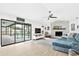 Open living room with access to a screened-in pool area and stone fireplace at 4612 Masefield Pl, Sarasota, FL 34241