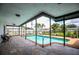Inviting covered patio overlooks a sparkling pool and landscaped backyard at 4612 Masefield Pl, Sarasota, FL 34241