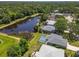 Aerial view reveals the home's peaceful setting near a tranquil pond in a verdant, residential neighborhood at 4758 Breezy Pines Blvd, Sarasota, FL 34232
