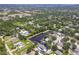An aerial view shows the location near 17th St Park with mature landscaping and a neighborhood pond at 4758 Breezy Pines Blvd, Sarasota, FL 34232