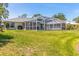 Well-maintained backyard featuring a screened-in pool and lush green lawn at 4758 Breezy Pines Blvd, Sarasota, FL 34232