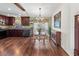 Eat-in kitchen with hardwood floors, dark cabinets, granite countertops and wrought iron table and chairs at 4758 Breezy Pines Blvd, Sarasota, FL 34232