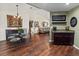 Open-concept dining area seamlessly connecting to the living room, hardwood flooring, and stylish decor at 4758 Breezy Pines Blvd, Sarasota, FL 34232
