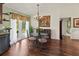 Charming dining room featuring hardwood floors, glass table, and french doors leading to the backyard at 4758 Breezy Pines Blvd, Sarasota, FL 34232