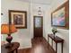 Elegant foyer with hardwood floors, decorative lighting, and stylish décor at 4758 Breezy Pines Blvd, Sarasota, FL 34232