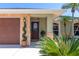 Inviting front entrance with well-maintained landscaping and a decorative glass front door at 4758 Breezy Pines Blvd, Sarasota, FL 34232