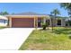 Inviting single-story home displaying a pristine lawn and an attached two-car garage at 4758 Breezy Pines Blvd, Sarasota, FL 34232
