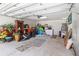 Spacious garage with neutral tile floor, overhead storage, and organized storage racks at 4758 Breezy Pines Blvd, Sarasota, FL 34232