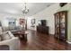 Spacious living room with hardwood floors, large windows, and a comfortable sofa at 4758 Breezy Pines Blvd, Sarasota, FL 34232