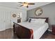 Serene main bedroom showcasing a decorative ceiling fan and mirror at 4758 Breezy Pines Blvd, Sarasota, FL 34232