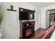 Bedroom with a fireplace, TV, and views of the ensuite bathroom and closet at 4758 Breezy Pines Blvd, Sarasota, FL 34232