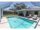Refreshing pool area with screened enclosure and stylish outdoor seating at 4758 Breezy Pines Blvd, Sarasota, FL 34232
