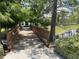Wooden bridge with railings leading over a canal, surrounded by lush greenery and trees at 4802 51St W St # 1724, Bradenton, FL 34210