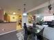 Open concept dining room featuring an eat-in kitchen, modern light fixture and sleek black dining set at 4802 51St W St # 1724, Bradenton, FL 34210